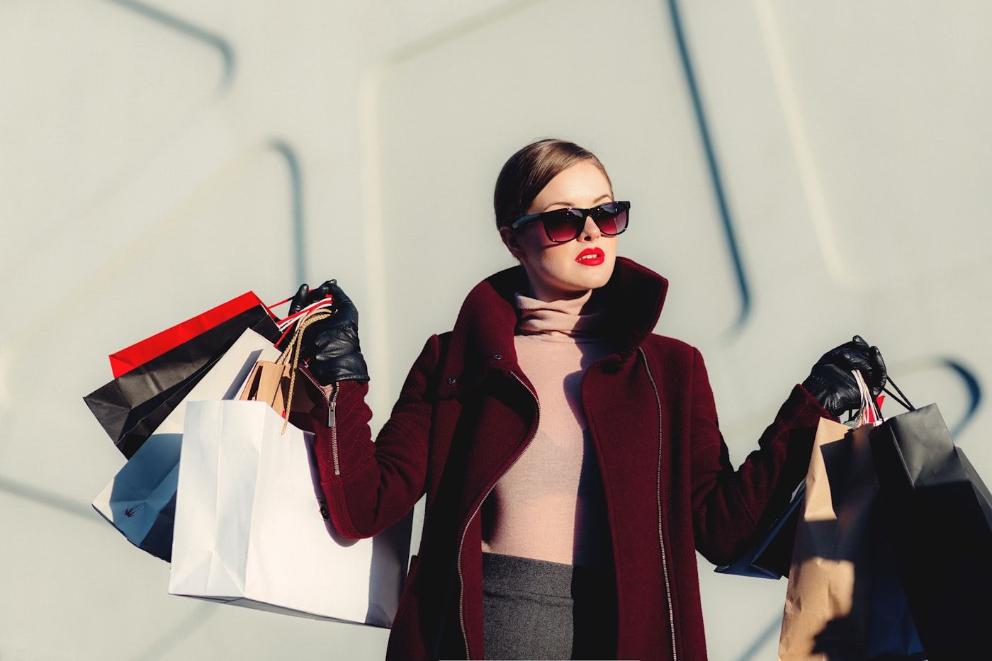 Editorial fashion photograph with shopping bags — paid social campaign creative, not a dashboard.
